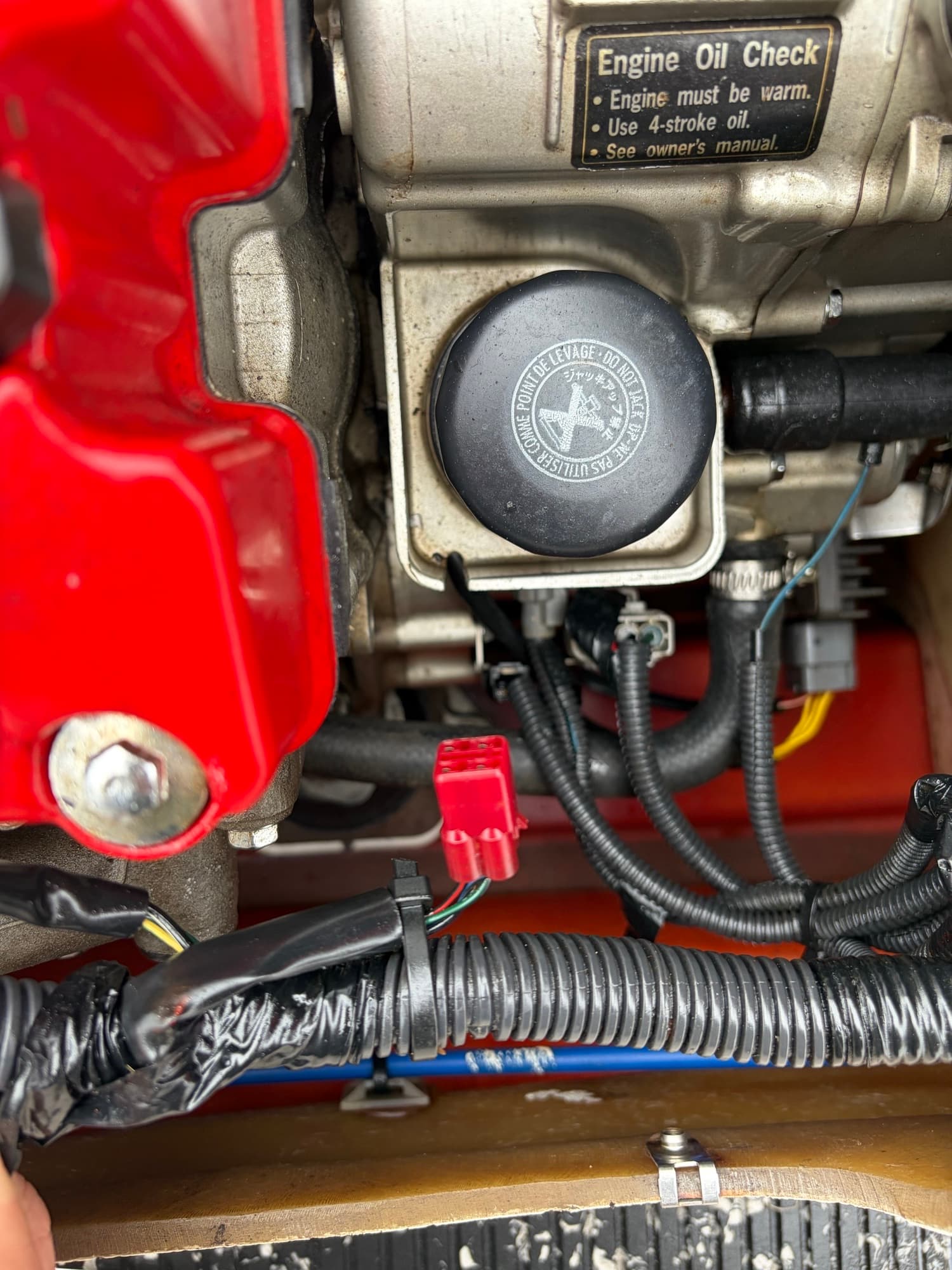 The red 4-pin DLC connector located in the engine bay of a Honda AquaTrax
